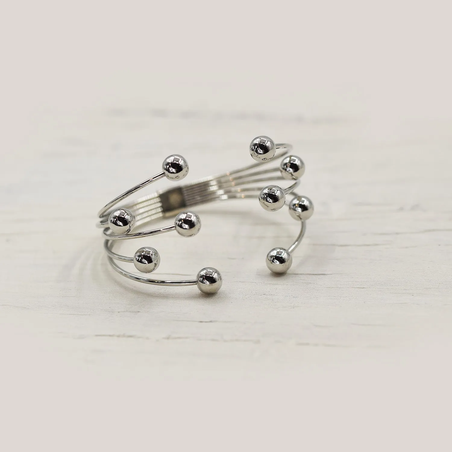 Delicate multi layer bangle with ball feature